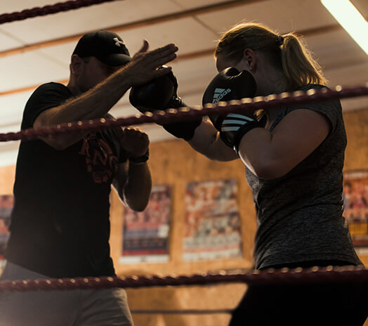 Ring3city boxing coach giving individual coaching to fighter in boxing ring
